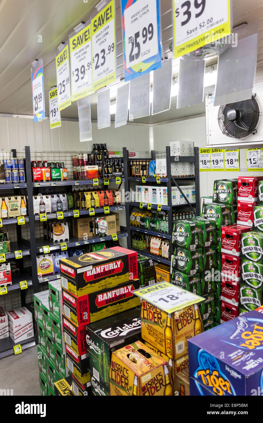 Different brands of beer in the walk in cold section in a New Zealand supermarket with discount signs. Stock Photo