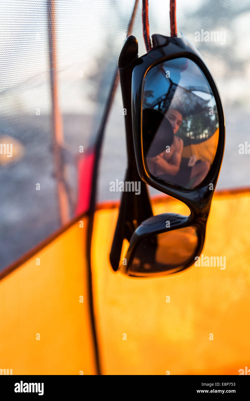 A camper's reflection in sunglasses, Pohjoinen Käärmeluoto island, Helsinki, Finland, Europe, EU Stock Photo