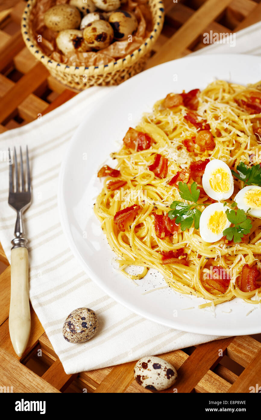 Pasta. Spaghetti with carbonara sauce, parmesan cheese, bacon and quail