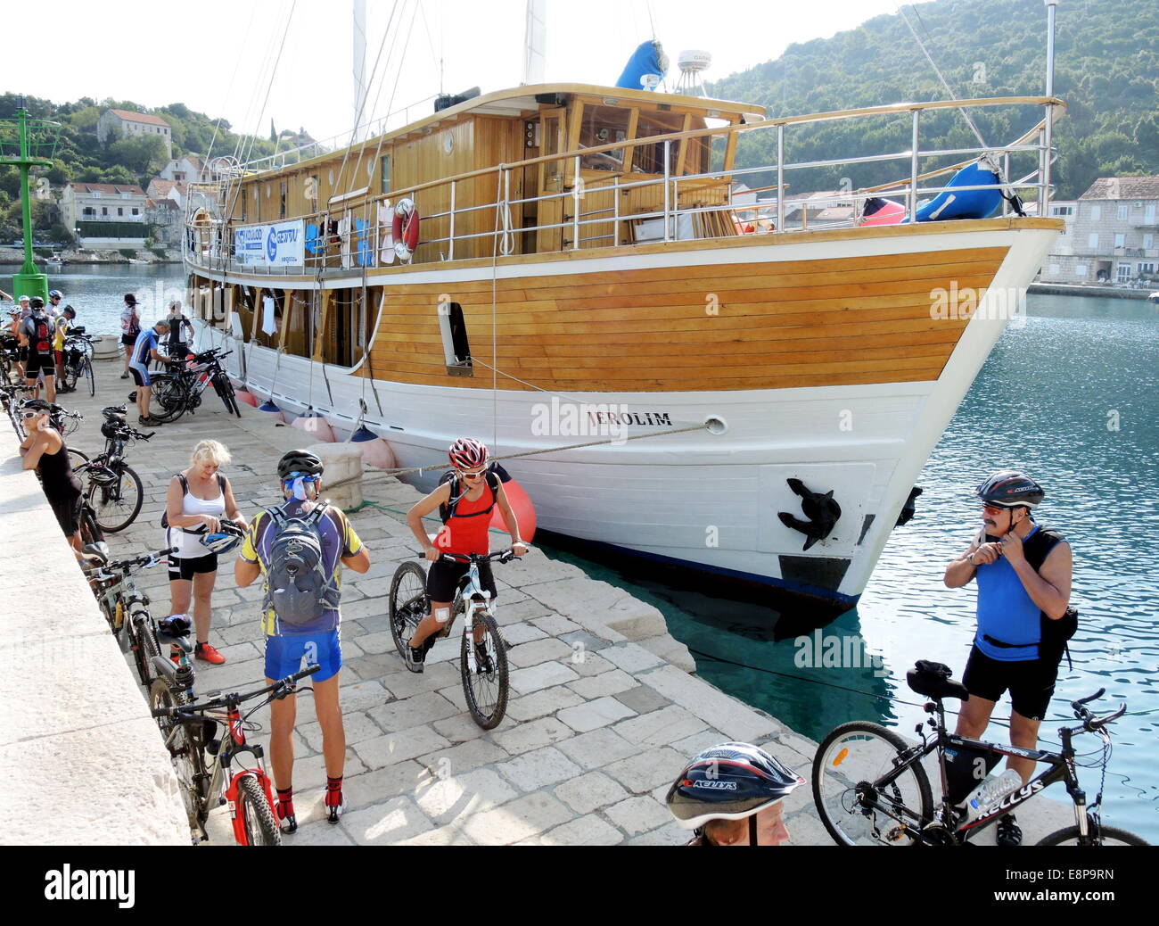 Guests of a tour operator, specialized in combined bike & boat tours in the Adriatic Sea of Croatia, start on September, 22, 2014, in Rascice on the Croatian island of Korcula, in front of their sailing boat for a bike tour. Stock Photo