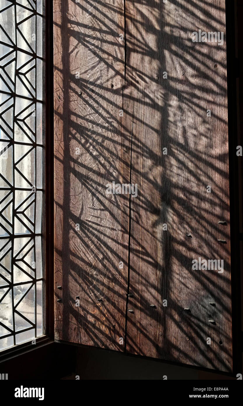 light shining through decorative window on wooden shutter Stock Photo