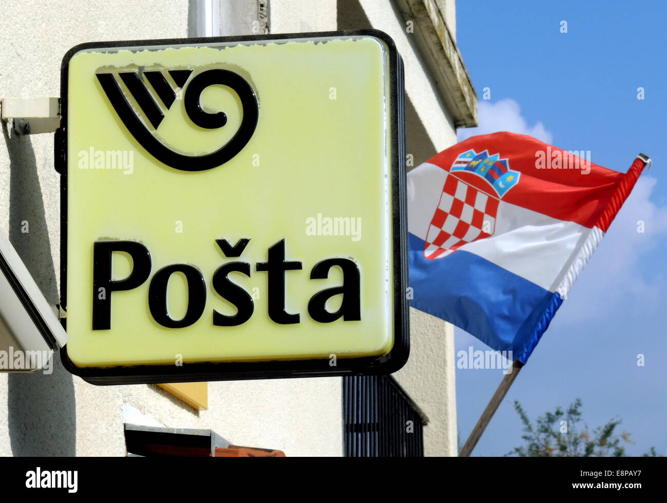 The Croatian national flag flutters on September, 22, 2014, at a post office in Racisce on the Croatian island of Korcula in the wind. Stock Photo