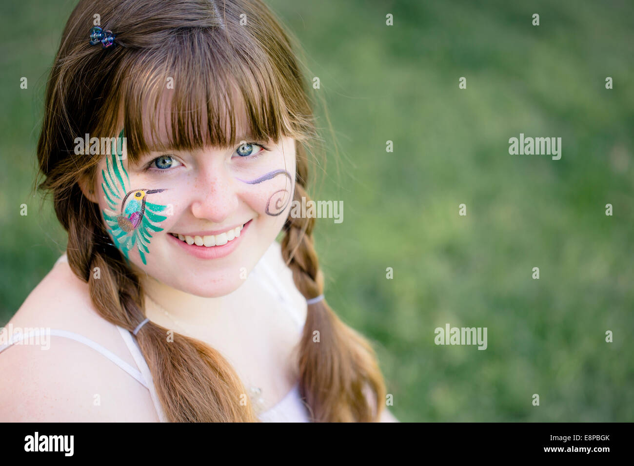 Girl (10-12) with painted face Stock Photo