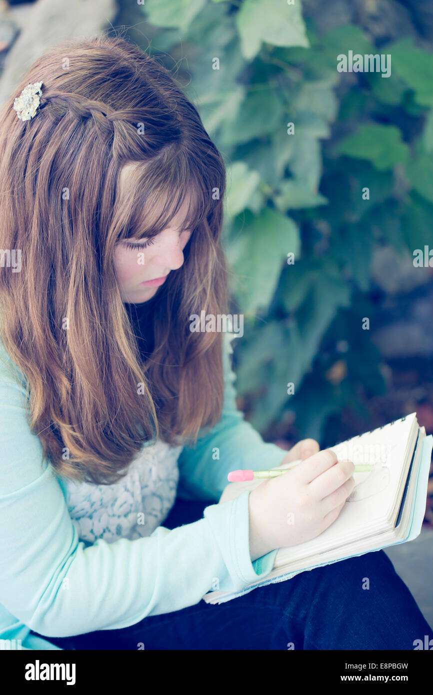 Portrait of teenage girl (13-15) writing Stock Photo