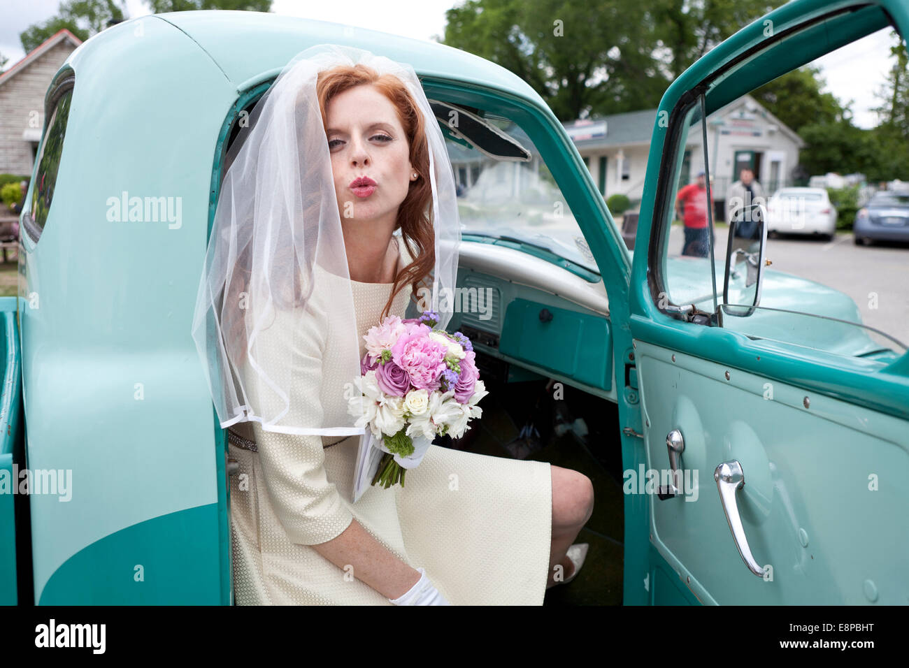 Portrait of bride in vintage car Stock Photo - Alamy