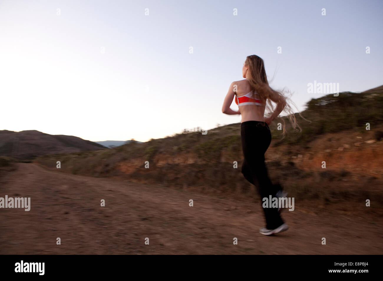Back view blonde woman running hi-res stock photography and images - Alamy