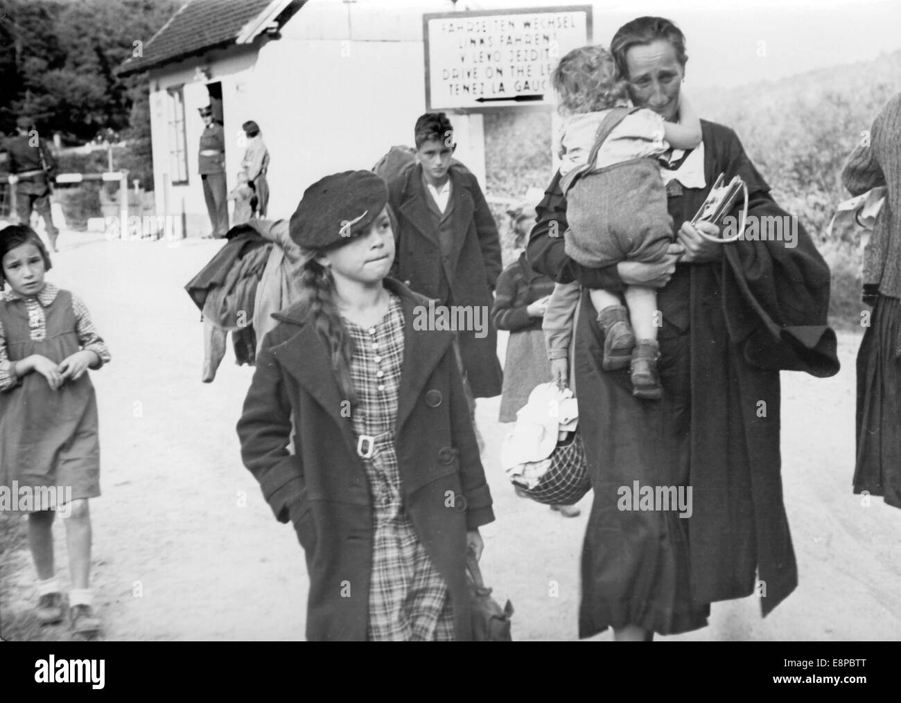 The picture from a Nazi news report shows a Sudeten German woman and child after saying goodbye to the father, who stayed back in Czechoslovakia, at the Austrian-Czech border in Hardegg, Austria, September 1939. The original Nazi propaganda text on the back of the picture reads: 'At the Ostmark-Czech border. Near Hardegg an der Thaya. The fates of Sudeten German families in their difficult tie. Women and children are brought to the border by the father. The Sudeten German farmer has to stay on his farm to take care of his possessions, the cow. Fotoarchiv für Zeitgeschichtee - NO WIRE SERVICE Stock Photo