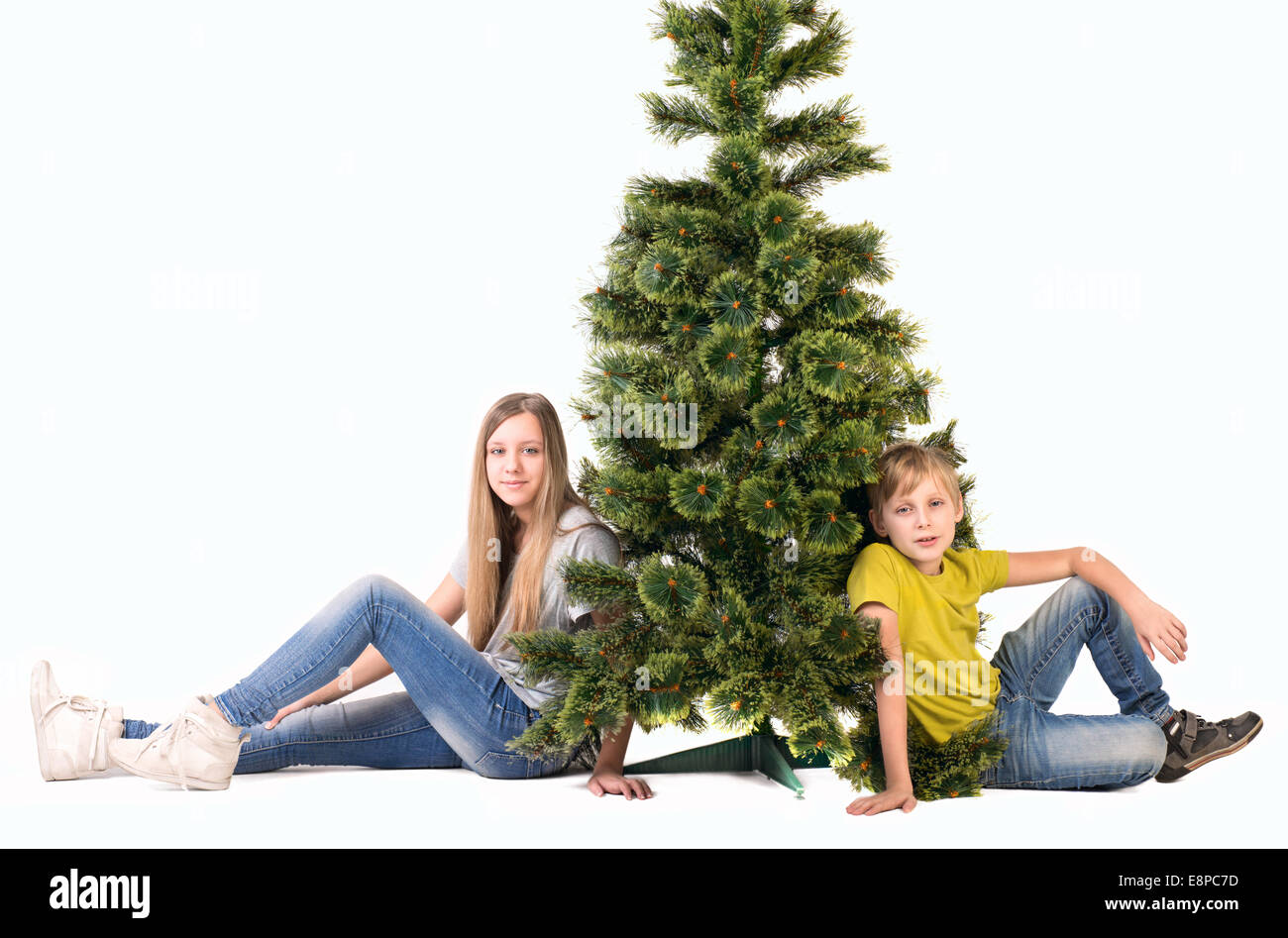 Boy and girl sitting under the tree Stock Photo - Alamy