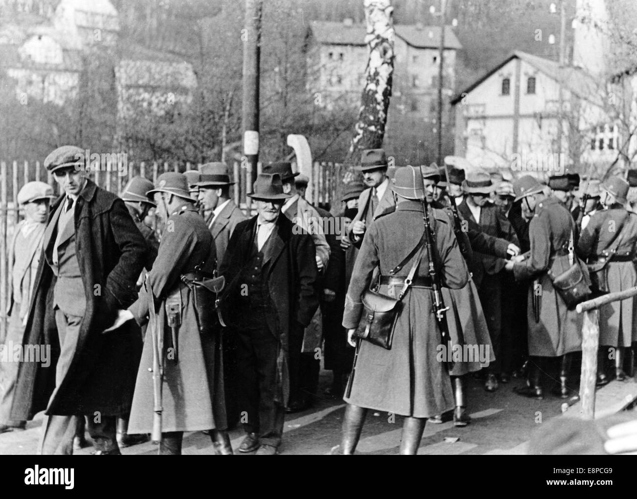 The picture from the Nazi news service shows supporters of the Sudeten German Party (SdP) being searched by armed Czech police officers on their way to an election meeting in the Sudetenland (today Czech Republic) in 1935. Fotoarchiv für Zeitgeschichtee - NO WIRE SERVICE Stock Photo