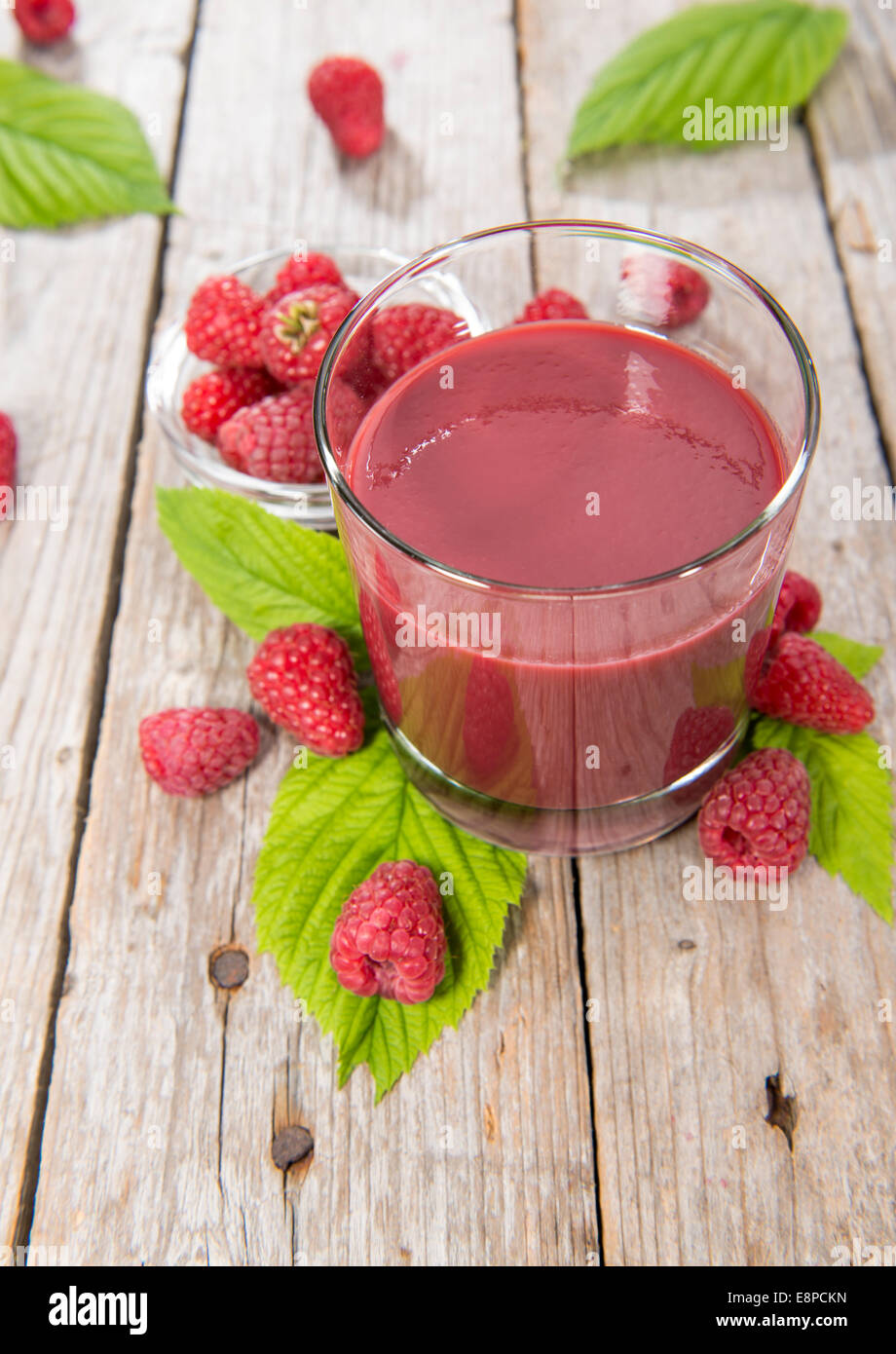 Portion of fresh made Raspberry Juice with some fruits Stock Photo