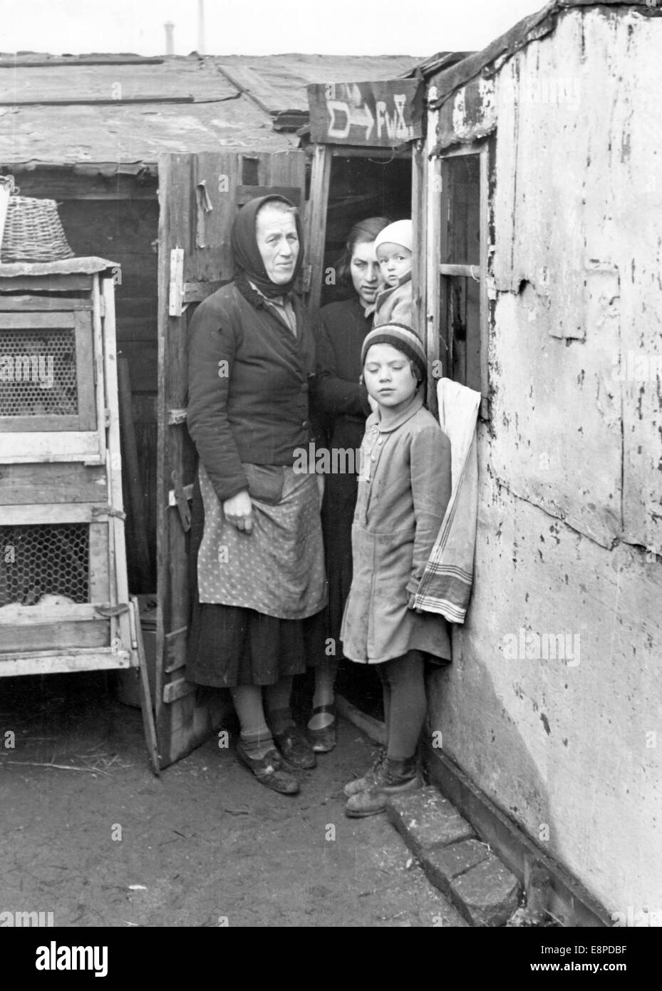 The poor housing of a Sudetenland German family near Karlsbad (Karlovy Vary, Czech Republic) in October 1938. The picture was used by Nazi propaganda to highlight the bad living conditions of Sudeten Germans in the Czech Republic. The Nazi news service writes on the back of the picture: 'From the slums of Fischern near Karlsbad. The entrance to a shack in the slum which is teeming with rats. 5 people live here including a 78 year old woman.' Fotoarchiv für Zeitgeschichtee - NO WIRE SERVICE Stock Photo