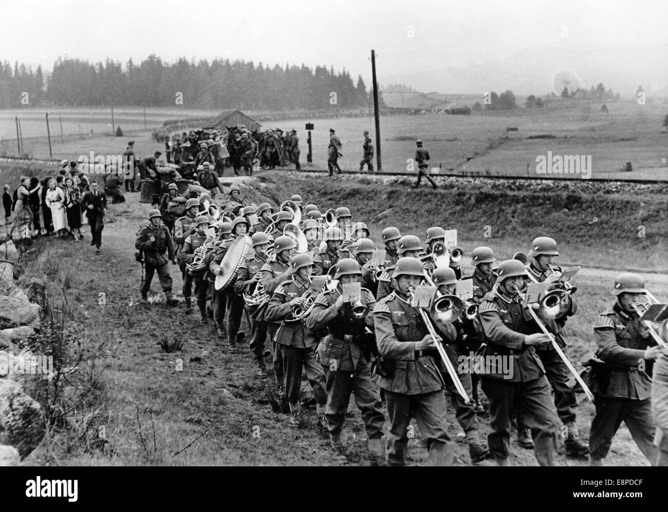The Nazi propaganda picture shows German Wehrmacht soldiers crossing the German-Czech border near Haidmuehle in the Sudetenland, October 1938. The original text from a Nazi news report on the back of the picture reads: 'The first pictures of the arrival of German troops in the Sudetenland (Division I). The German soldiers march into the liberated Sudetenland to the sound of a military band. (At the border near Haidmuehle).' Fotoarchiv für Zeitgeschichtee - NO WIRE SERVICE Stock Photo