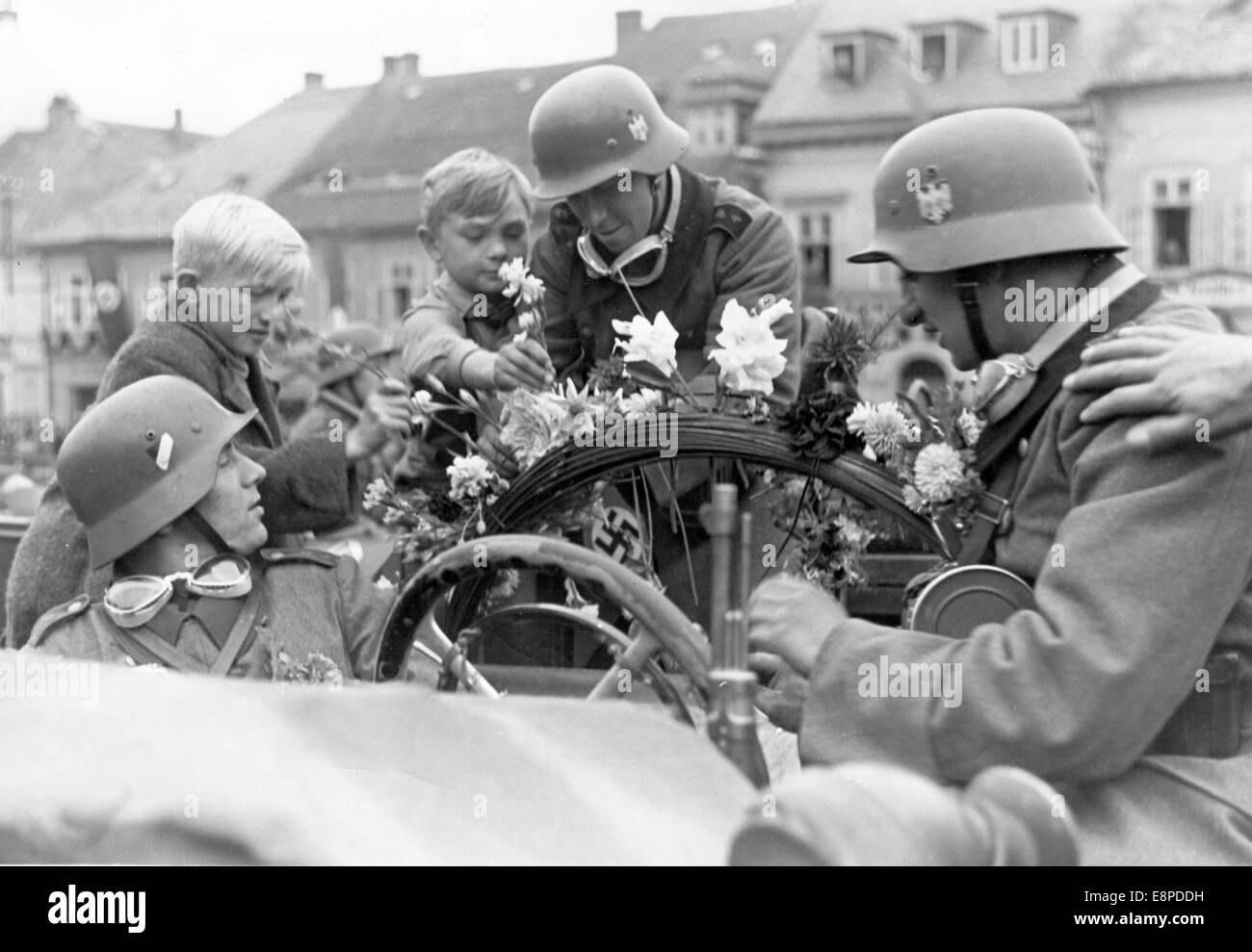 The Nazi propaganda picture shows the celebrations as German troops arrive in Schluckenau, Sudetenland (today, Sluknov, Czech Republic) in October 1938. The original text from a Nazi news report on the back of the picture reads: 'Excited reception for German troops in Schluckenau. The cheers and excitement was indescribable as German troops marched into Schluckenau. Women and children couldn't do enough to decorate the soldiers with flowers and to express the happy feelings in the most beautiful of ways.' Fotoarchiv für Zeitgeschichtee - NO WIRE SERVICE Stock Photo