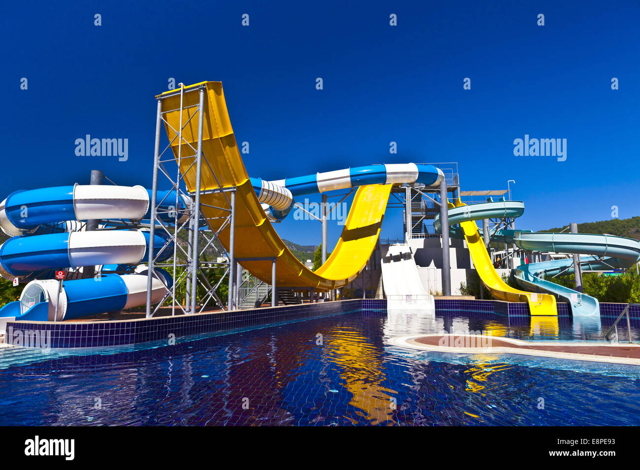 Blue, white and yellow waterslide in a pool. Stock Photo
