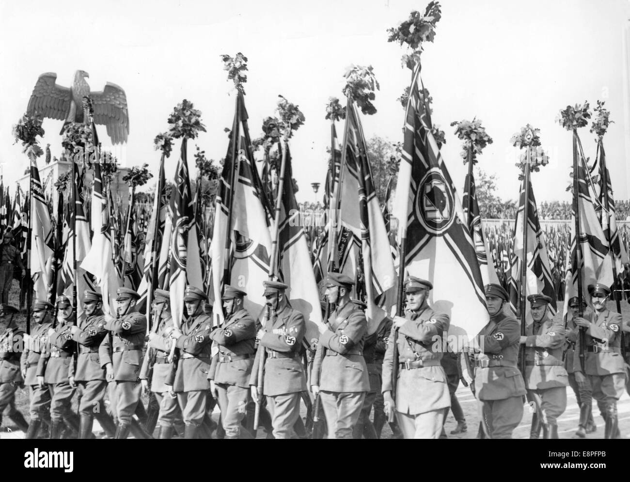 Nuremberg Rally 1934 in Nuremberg, Germany - Flag bearers of the SA (Sturmabteilung) reserve unit 2 (Stahlhelm) are on parade at the Nazi party rally grounds. (Flaws in quality due to the historic picture copy) Fotoarchiv für Zeitgeschichtee - NO WIRE SERVICE - Stock Photo