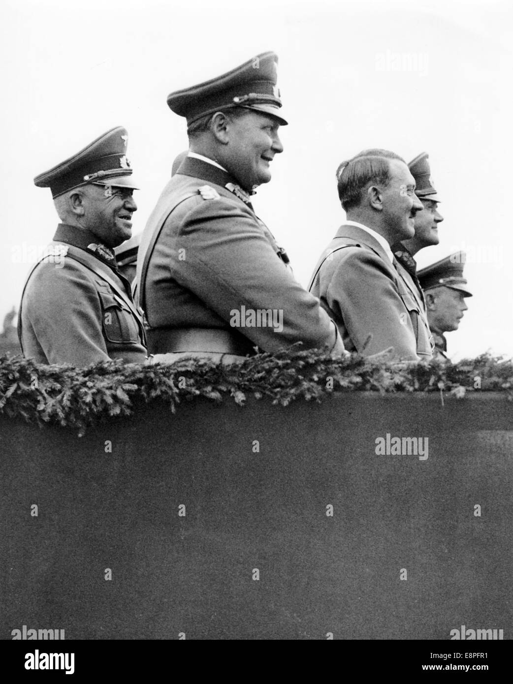 Nuremberg Rally 1934 in Nuremberg, Germany - Hermann Goering (Front L-R), Adolf Hitler, Werner von Blomberg (Reich Minister of War) and Werner von Fritsch (member of the German High Command) in front of the grandstand during a display by the Wehrmacht (armed forces) at Zeppelin Field at the Nazi party rally grounds. (Flaws in quality due to the historic picture copy) Fotoarchiv für Zeitgeschichtee - NO WIRE SERVICE - Stock Photo
