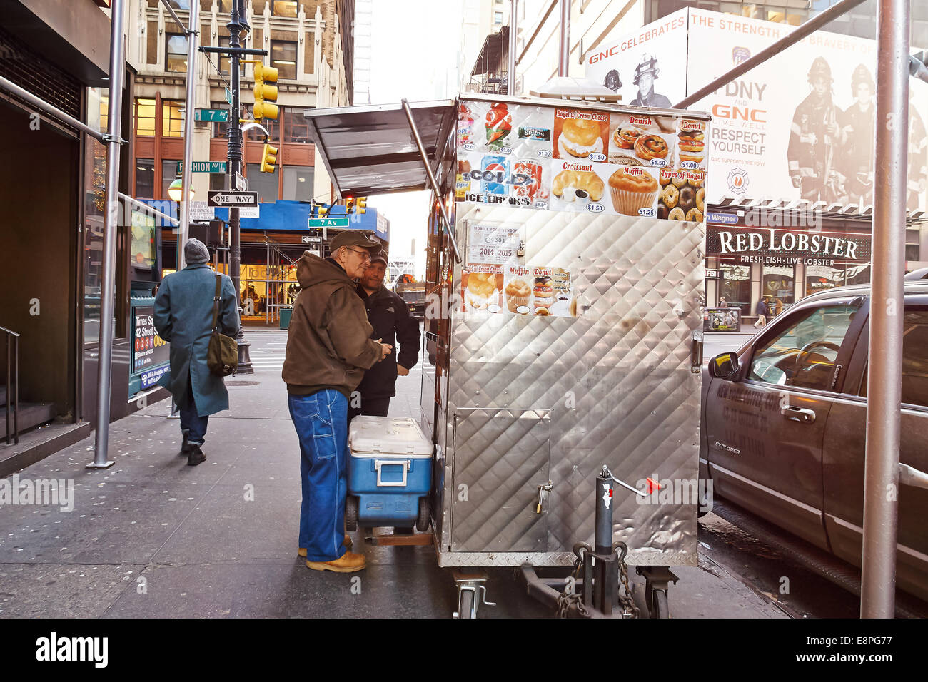 Street vendor cart and customers. Stock Photo
