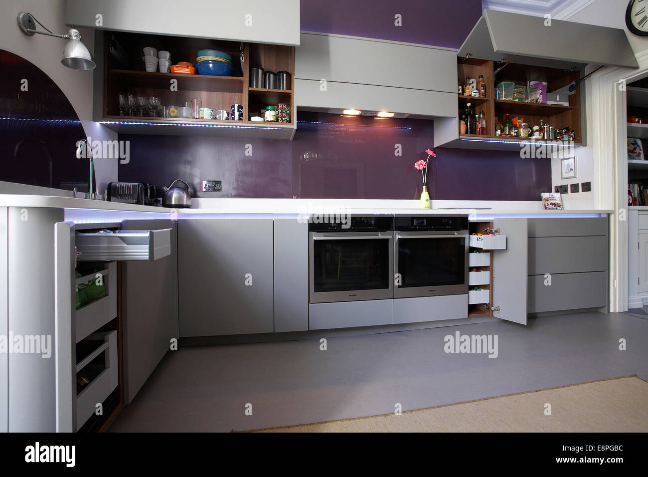 A Modern Kitchen Inside A Home In The Uk With Cupboard Doors Open Stock Photo Alamy
