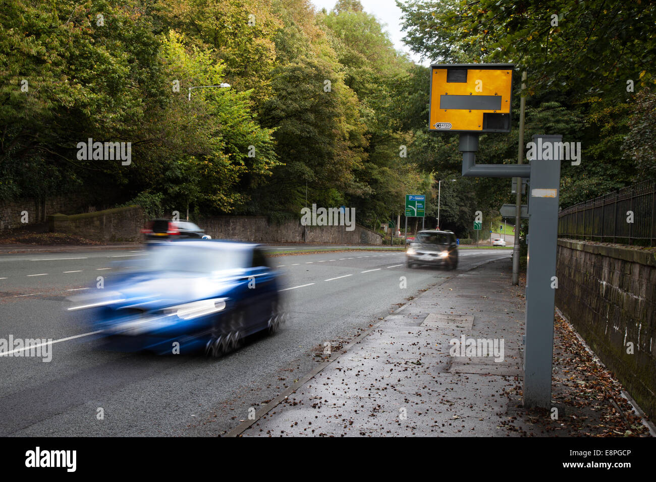 Blurred city centre Moving traffic; Road vehicles speeding passing Gatso Meter, Traffic Speed Camera, Penwortham, Preston, Lancashire, UK Stock Photo