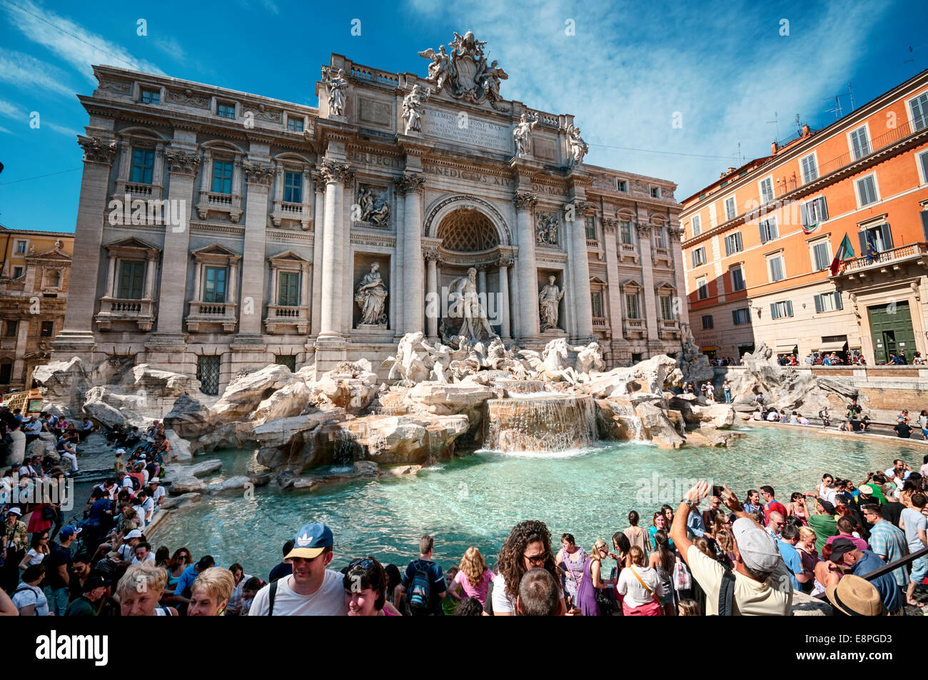 Rome, Italy - May 12, 2012: Tourists visiting the Trevi Fountain. Trevi Fountain is an iconic symbol of Imperial Rome. It is one Stock Photo