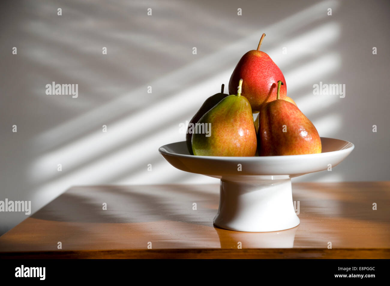pears in a bowl in sunlight Stock Photo