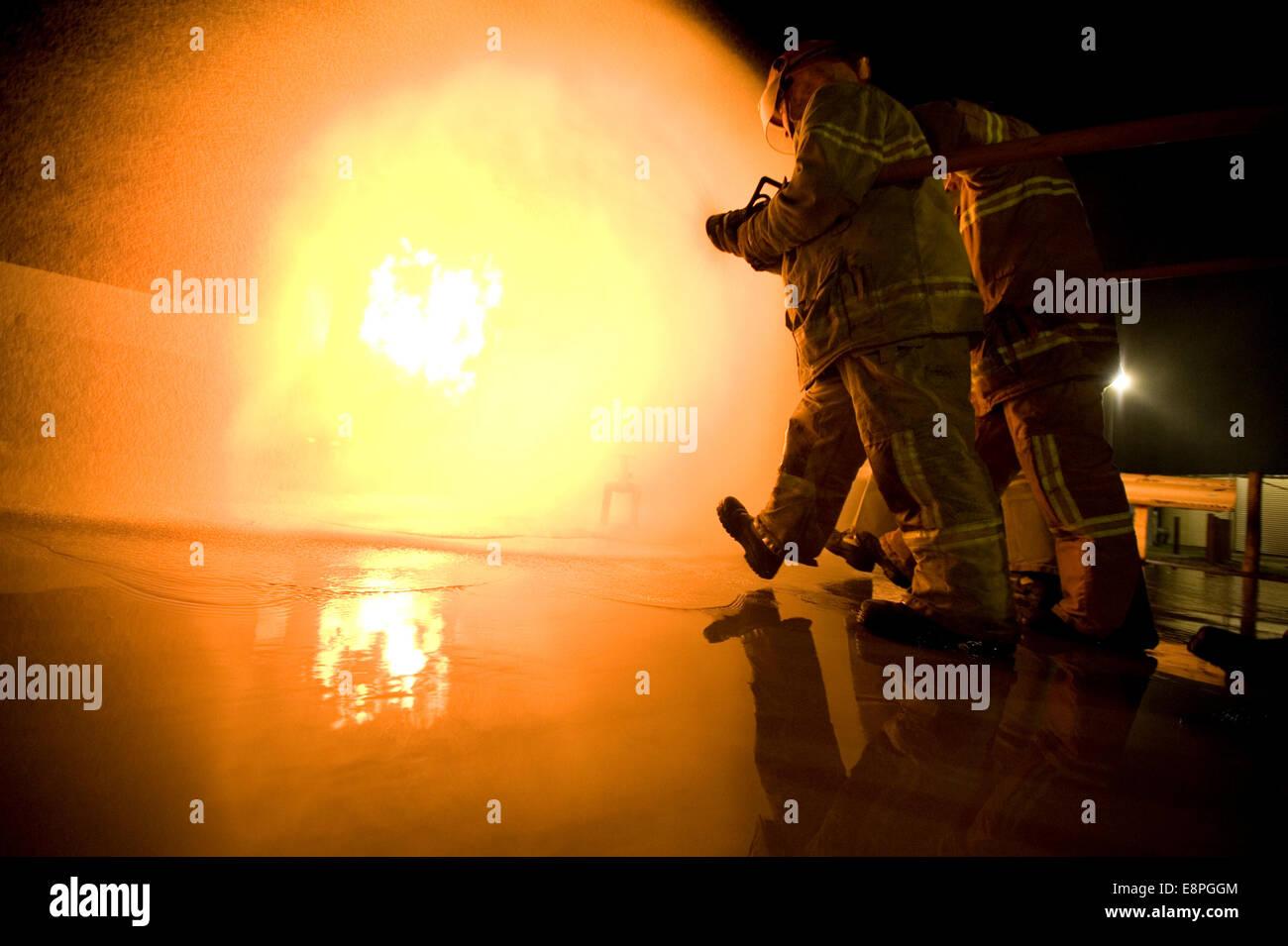 firefighters attack a gas fire Stock Photo