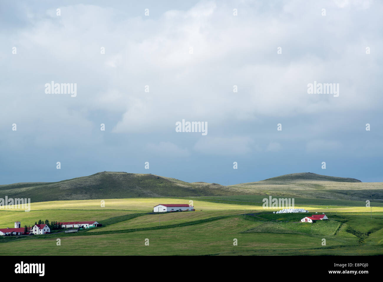 Beautiful view of several houses in a green field Stock Photo - Alamy