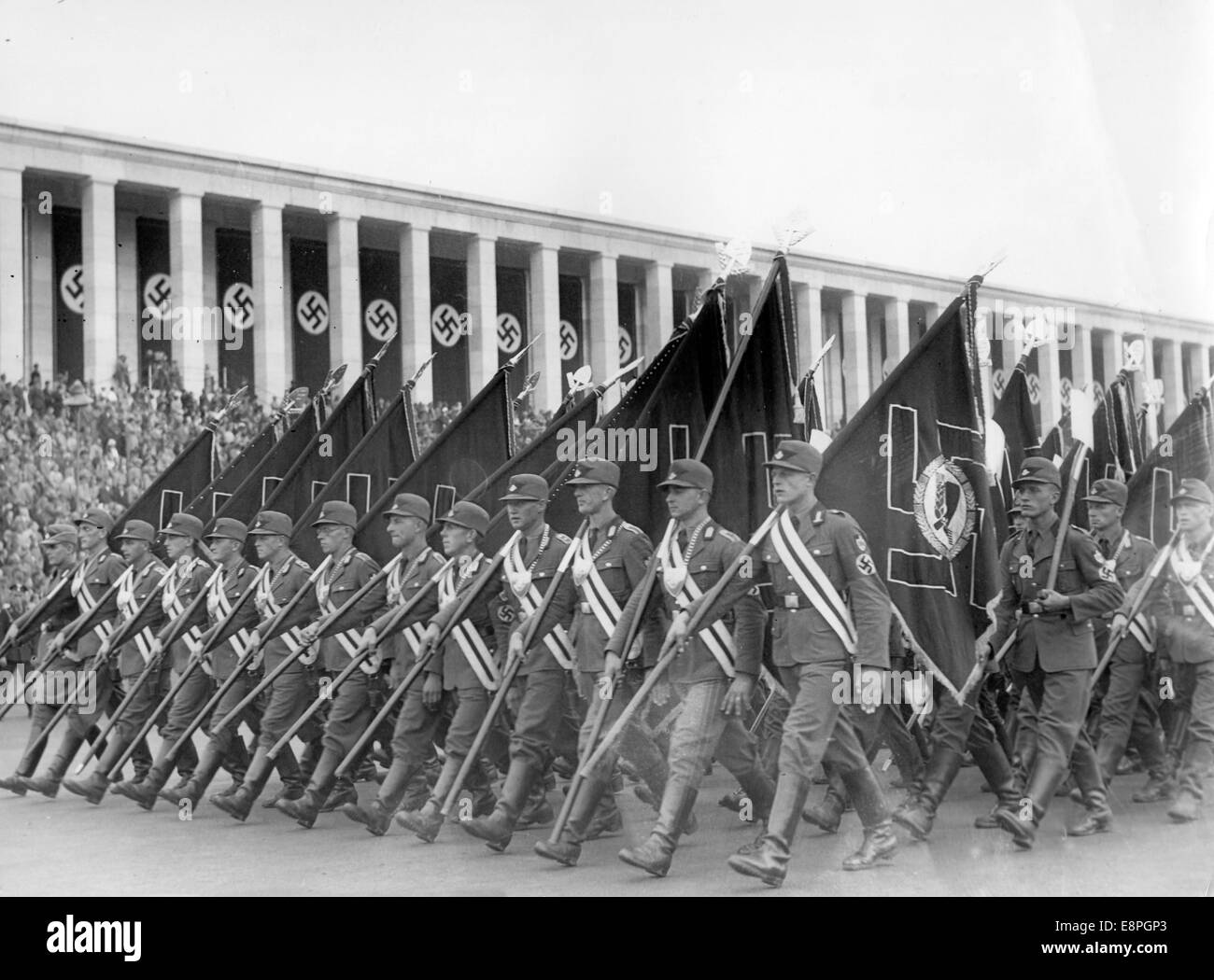 Nuremberg Rally 1936 in Nuremberg, Germany - Members of the Reich Labour Service (RAD) carry flags as they march past the grandstand on Zeppelin Field at the Nazi party rally grounds. Flaws in quality due to the historic picture copy) Fotoarchiv für Zeitgeschichtee - NO WIRE SERVICE – Stock Photo