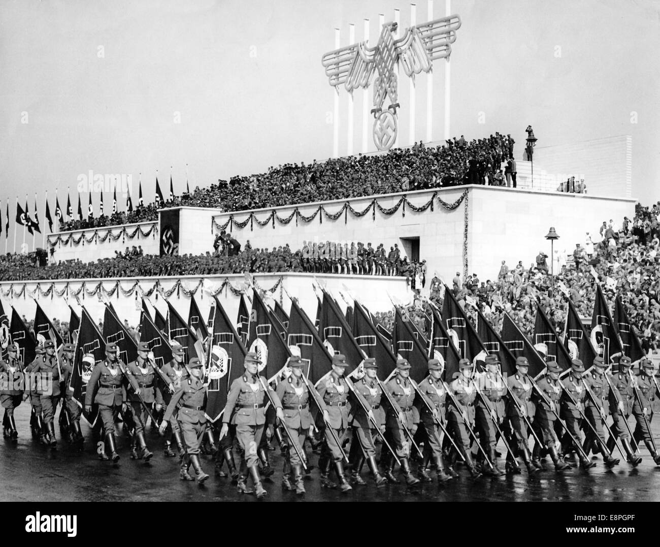 Nuremberg Rally 1935 in Nuremberg, Germany - Members of the Reichsarbeitsdienst (Reich Labour Service, RAD) march past the newly erected grandstand on Zeppelin Field during a roll call. (Flaws in quality due to the historic picture copy) Fotoarchiv für Zeitgeschichtee - NO WIRE SERVICE - Stock Photo