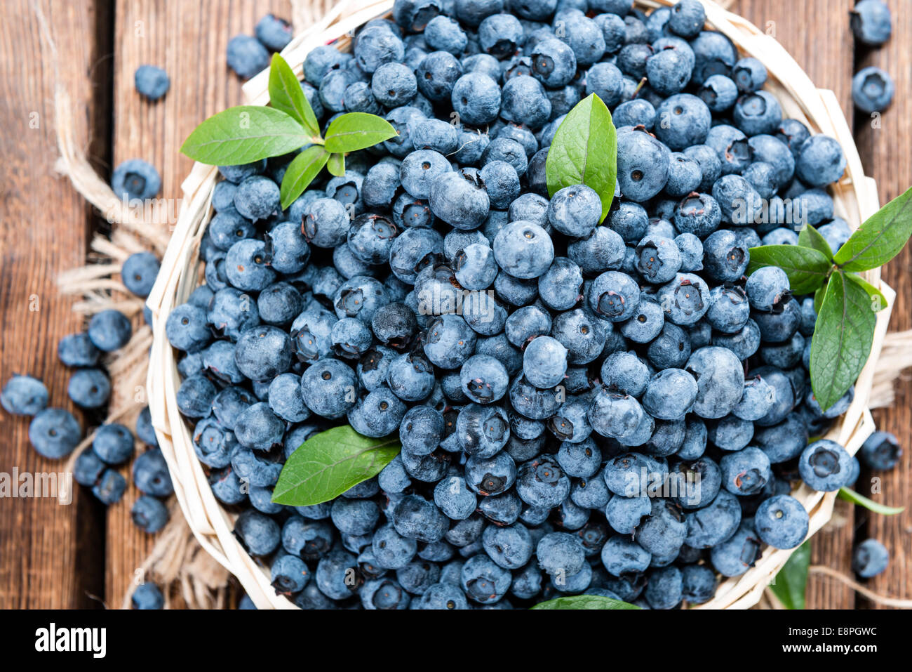 Portion of fresh harvested Blueberries on vintage wooden background
