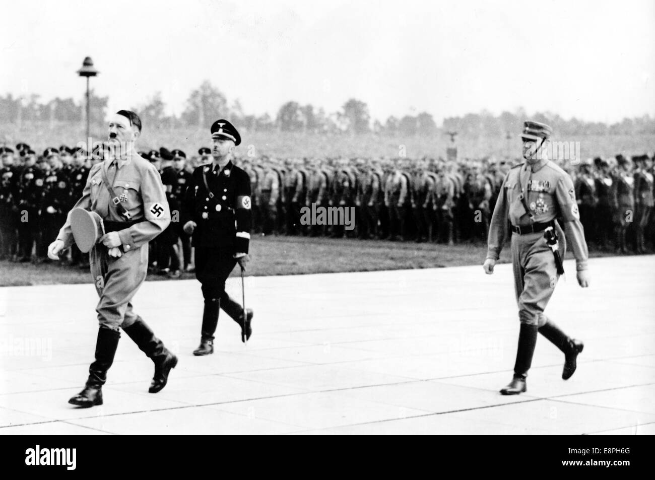 Nuremberg Rally 1937 in Nuremberg, Germany - Nazi party rally grounds - Adolf Hitler walks to the speaker's platform after the commemoration of the dead at the Hall of Honour with Reichsfuehrer of the Schutzstaffel (SS) Heinrich Himmler (2-L) and commander of the Sturmabteilung (SA) Viktor Lutze (R). (Flaws in quality due to the historic picture copy) Fotoarchiv für Zeitgeschichtee - NO WIRE SERVICE - Stock Photo