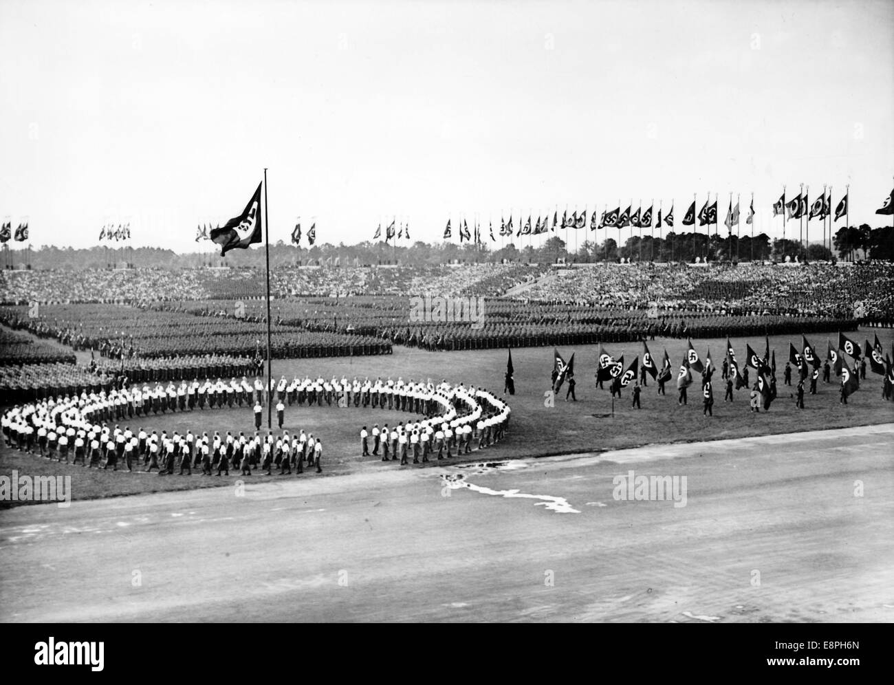 Nuremberg Rally 1937 in Nuremberg, Germany - Roll call of the Reich Labour Service (RAD) in front of the grandstand at Zeppelin Field on the Nazi party rally grounds - female members of the RAD have formed a circle. (Flaws in quality due to the historic picture copy) Fotoarchiv für Zeitgeschichtee - NO WIRE SERVICE - Stock Photo