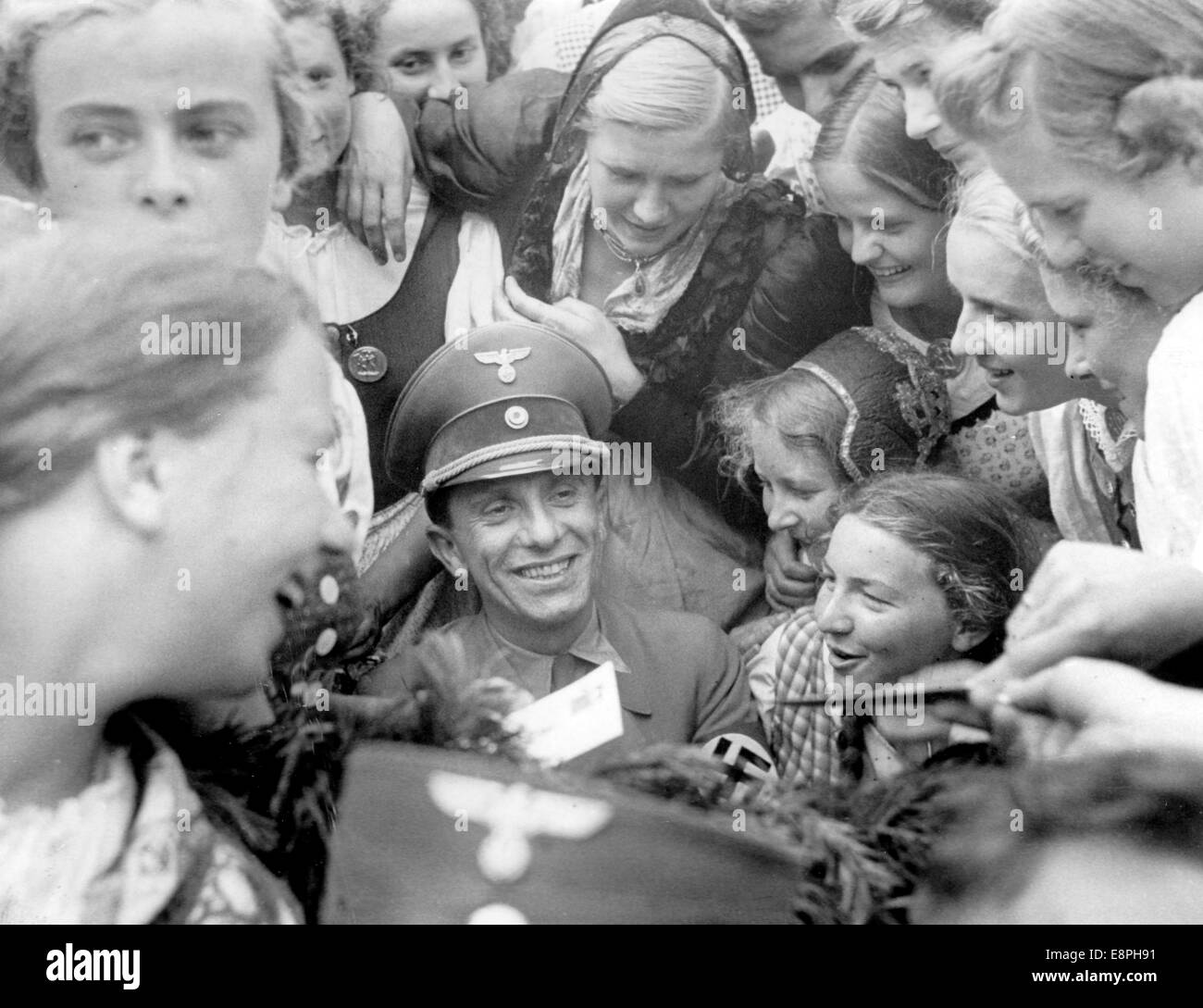Nuremberg Rally 1938 in Nuremberg, Germany - Reich Minister of Propaganda Joseph Goebbels is surrounded by girls from the Ostmark, who would like to have an autograph by him. (Flaws in quality due to the historic picture copy) Fotoarchiv für Zeitgeschichtee - NO WIRE SERVICE - Stock Photo