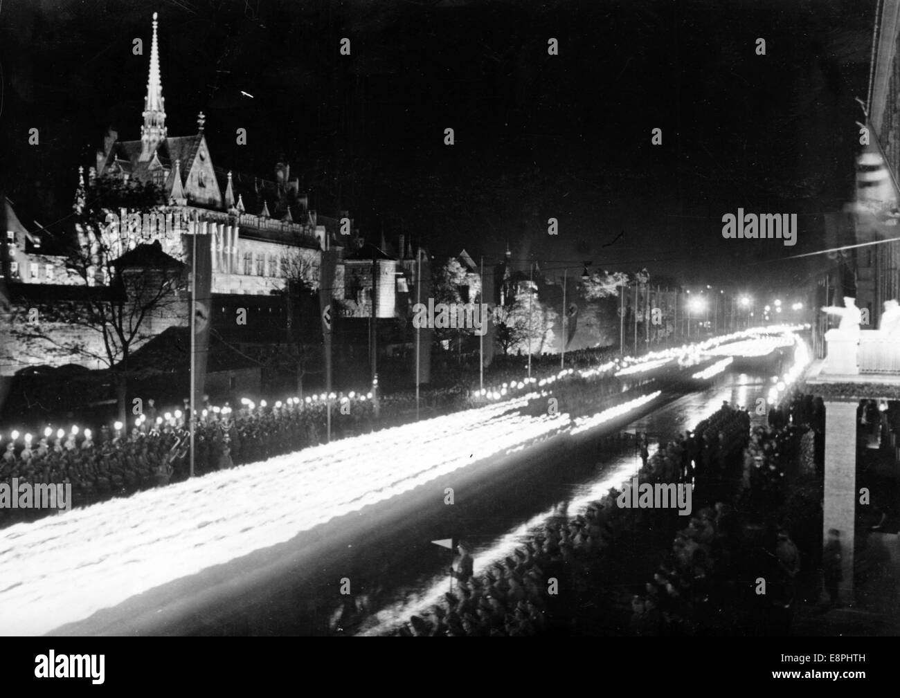 Nuremberg Rally 1937 in Nuremberg, Germany - The great torchlight procession of the political leaders marches past Adolf Hitler (R) on the balcony oh hotel 'Deutscher Hof'. (Flaws in quality due to the historic picture copy) Fotoarchiv für Zeitgeschichtee - NO WIRE SERVICE - Stock Photo