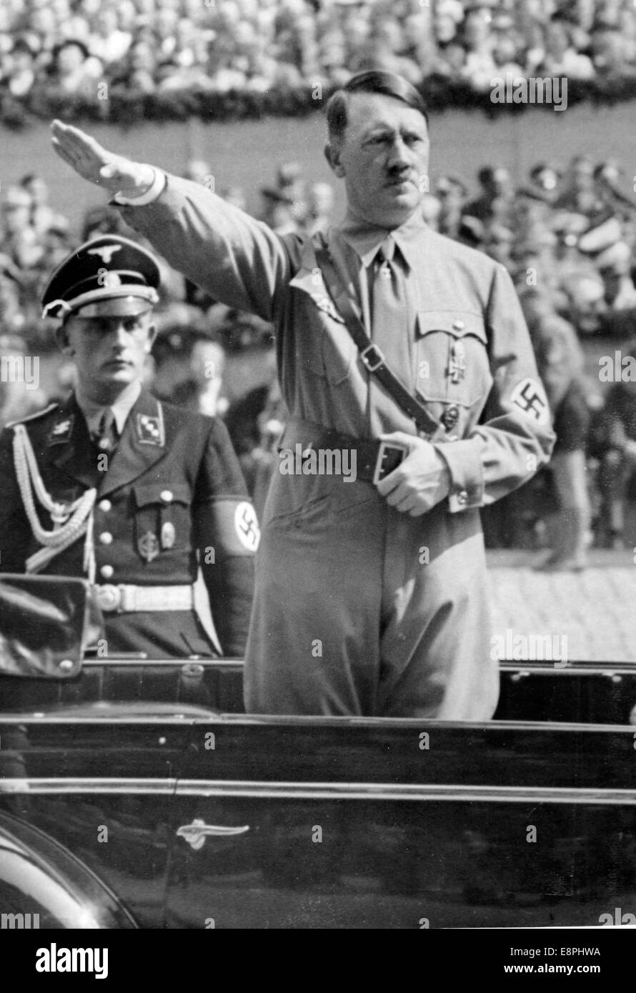 Nuremberg Rally 1938 in Nuremberg, Germany - Adolf Hitler stands in a car and takes the salute during a march-past of groups of the NSDAP and the Sturmabteilung (SA) on Adolf-Hitler-Square. (Flaws in quality due to the historic picture copy) Fotoarchiv für Zeitgeschichtee - NO WIRE SERVICE - Stock Photo