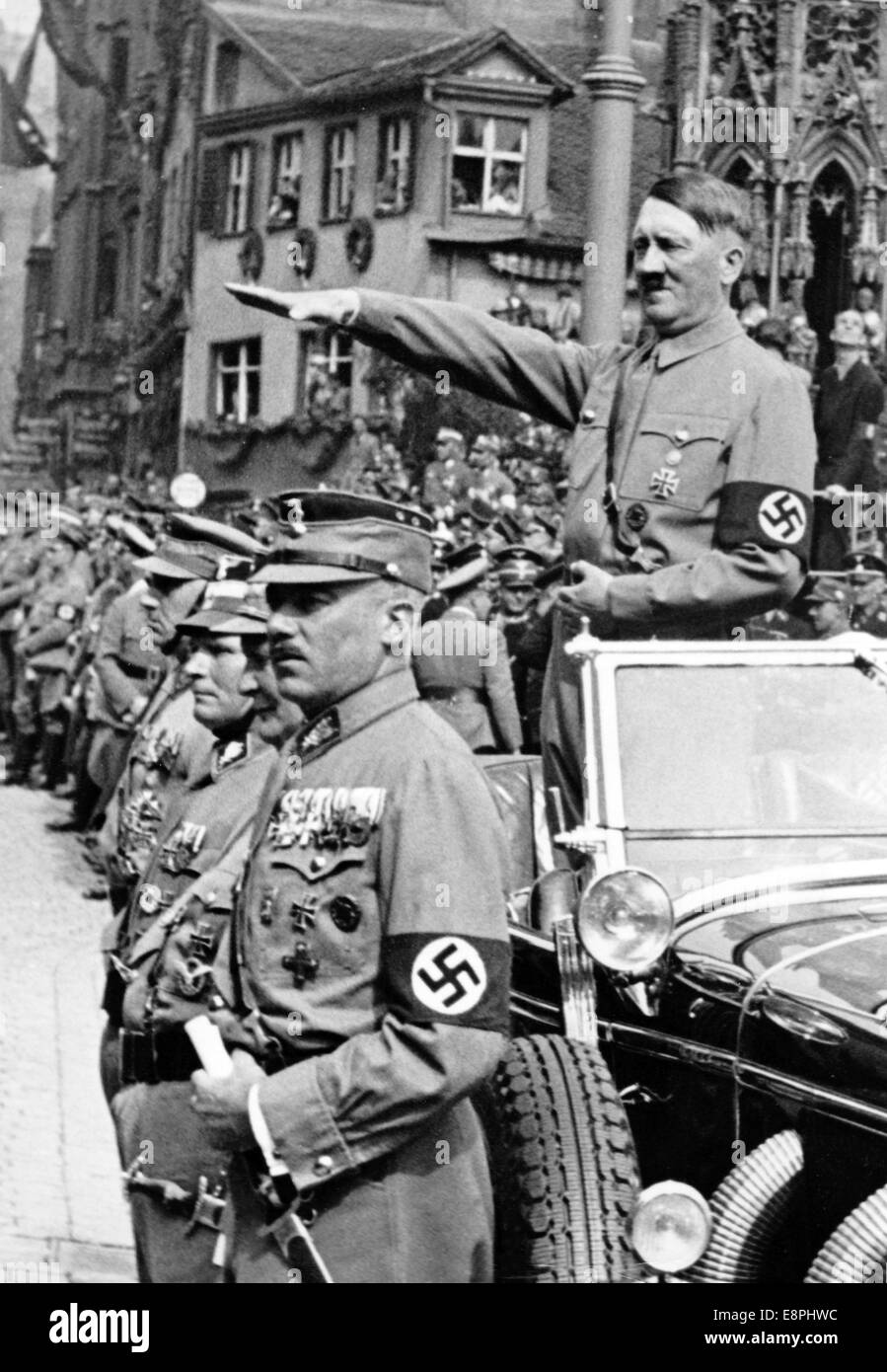 Nuremberg Rally 1937 in Nuremberg, Germany - Adolf Hitler salutes the march-past of the Sturmabteilung (SA) on Adolf-Hitler-Square. In front of Hitler: commander of the SA Viktor Lutze (L), Reich Minister Hermann (2-R) and SA functionary Franz von Pfeffer. (Flaws in quality due to the historic picture copy) Fotoarchiv für Zeitgeschichtee - NO WIRE SERVICE - Stock Photo