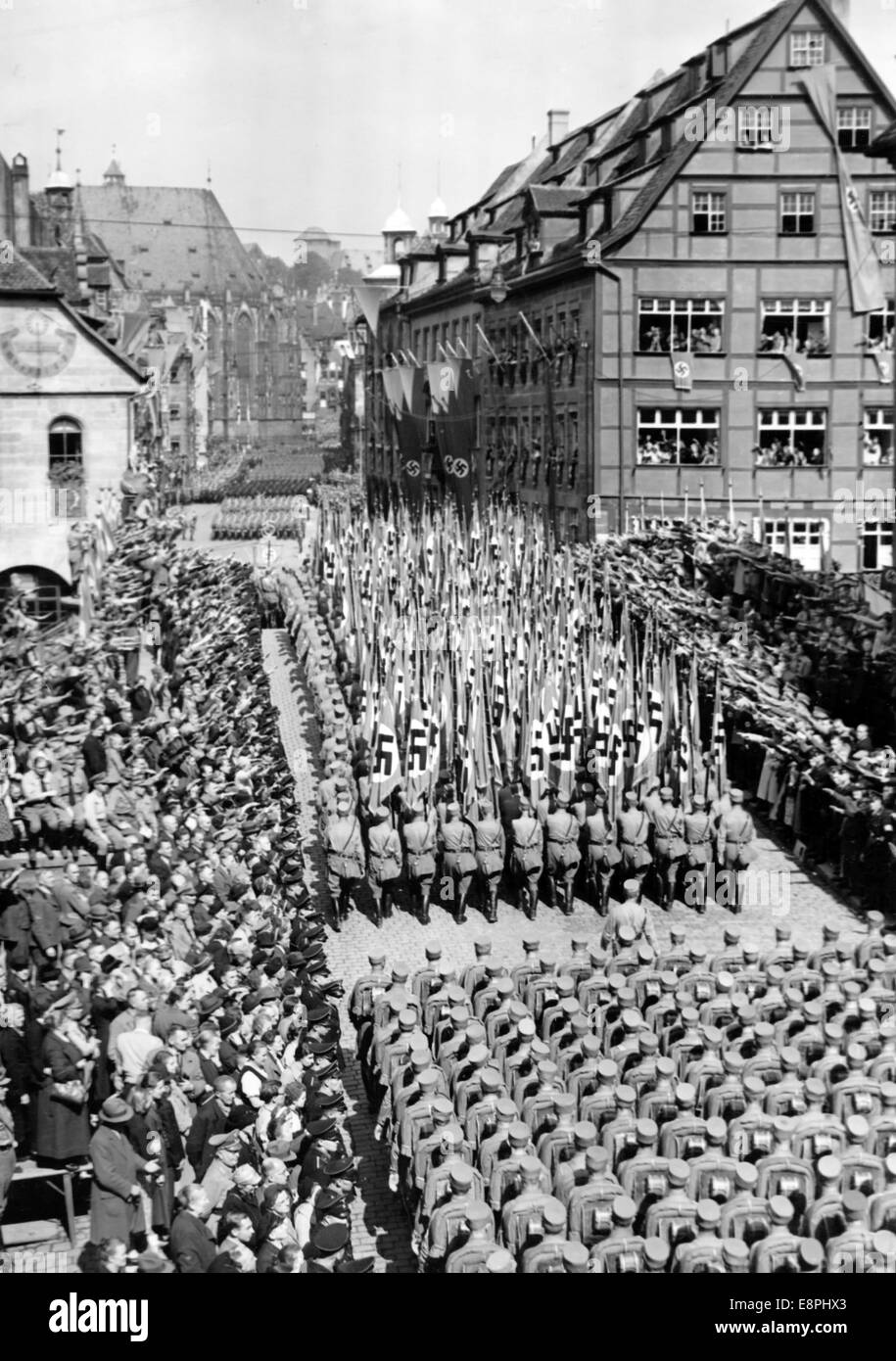 Nuremberg Rally 1938 in Nuremberg, Germany - Members of the Sturmabteilung (SA) march past houses decorated with wreaths and swastikas across Fleisch Bridge and are greeted with the Nazi salute in Nuremberg. (Flaws in quality due to the historic picture copy) Fotoarchiv für Zeitgeschichtee - NO WIRE SERVICE - Stock Photo