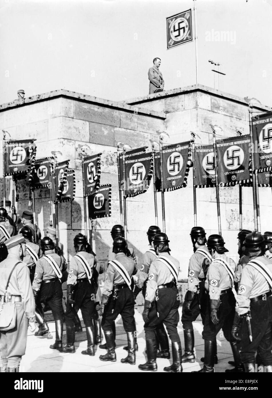 Nuremberg Rally 1938 in Nuremberg, Germany - March-past of the standards past Adolf Hitler and their setting up on the grandstand for the great roll call of the Sturmtruppe (SA), Schutzstaffel (SS), National Socialist Motor Corps (NSKK) and National Socialist Flyers Corps (NSFK) at Puitpoldarena at the Nazi party rally grounds. (Flaws in quality due to the historic picture copy) Fotoarchiv für Zeitgeschichtee - NO WIRE SERVICE - Stock Photo