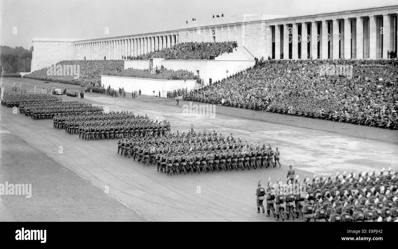 Nuremberg Rally 1937 in Nuremberg, Germany - The Reich Labour Service (RAD) marches past Adolf Hitler (in the car) in front of the grandstand on Zeppelin Field at the Nazi party rally grounds. Fotoarchiv für Zeitgeschichtee - NO WIRE SERVICE – Stock Photo