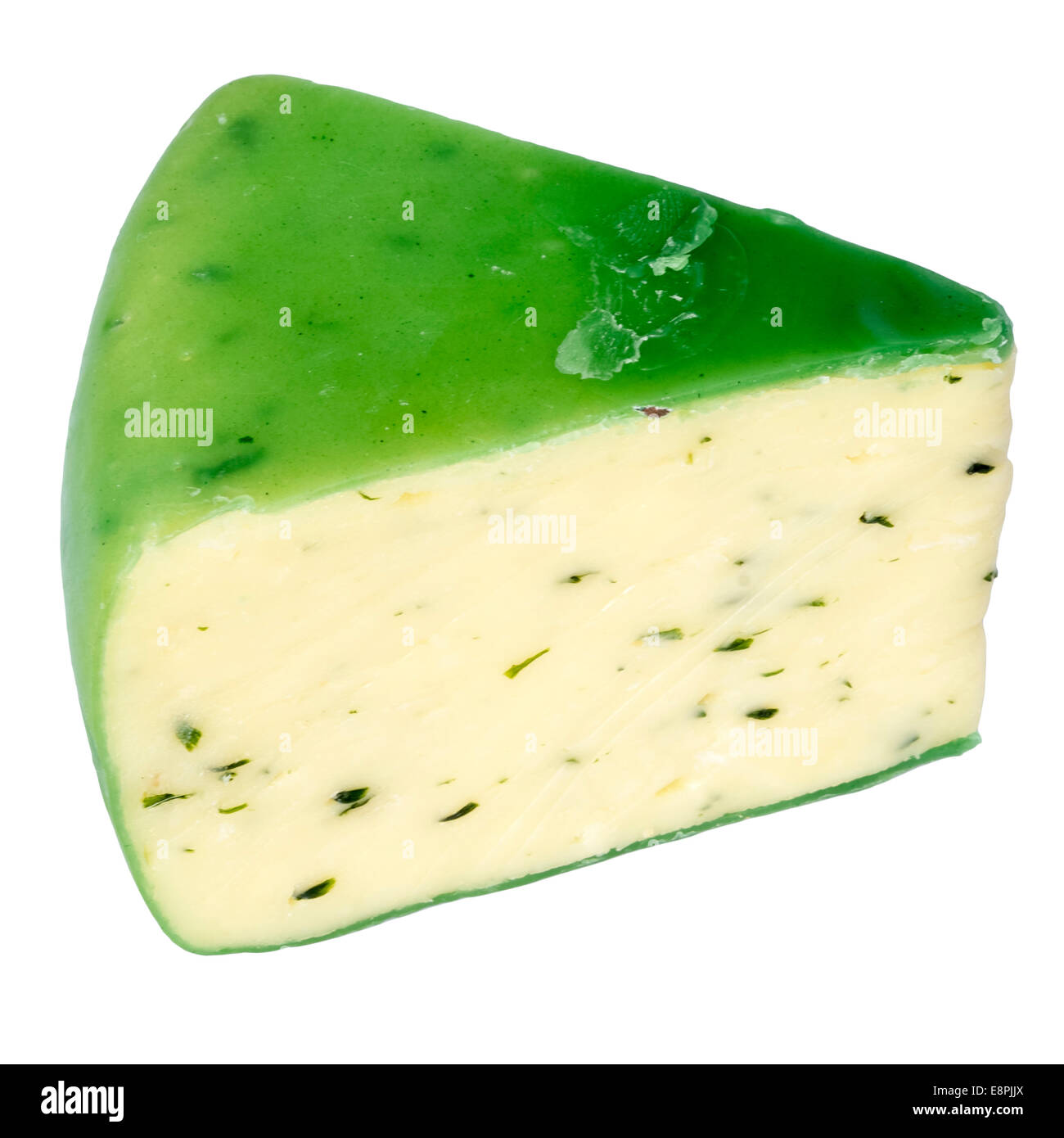 Wedge of Cheddar cheese & chives, cut out or isolated against a white background. Cheese sealed with green wax. Stock Photo