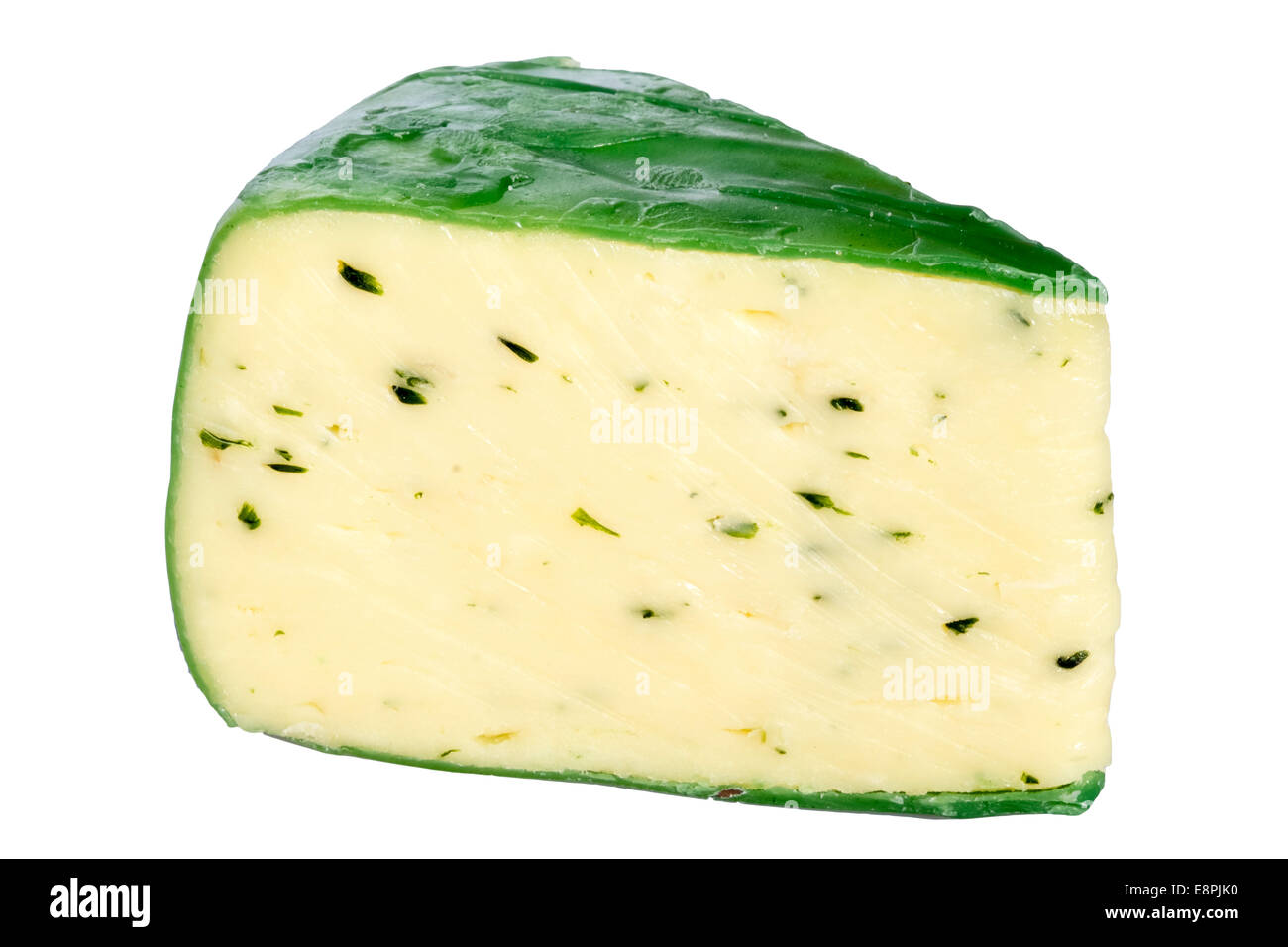 Wedge of Cheddar cheese & chives, cut out or isolated against a white background. Cheese sealed with green wax. Stock Photo