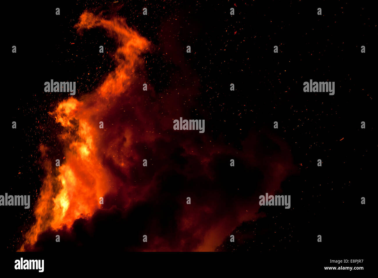 Large bonfire against a black night's sky making incredible shapes Stock Photo