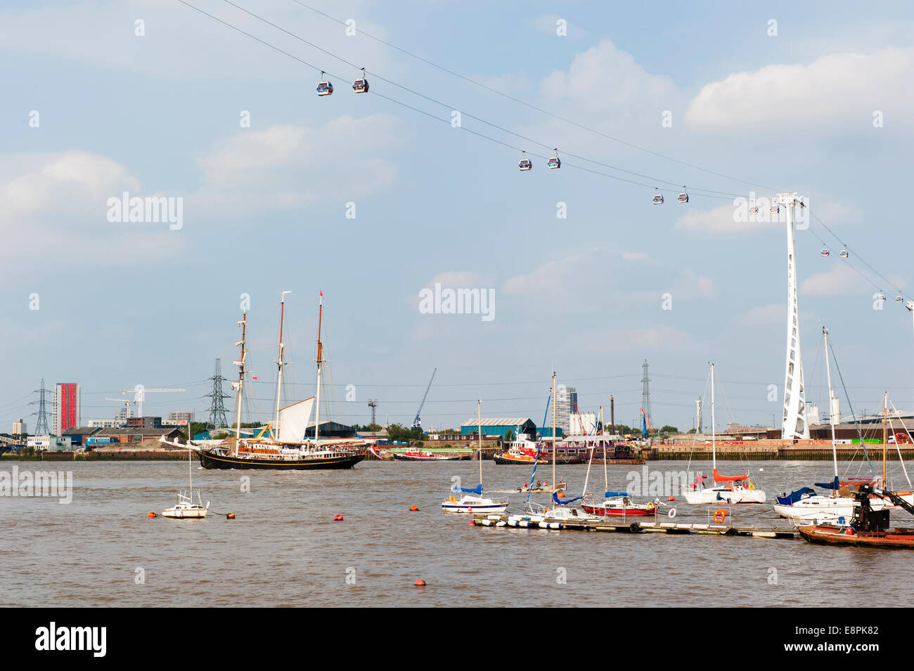 Tall Ship and a number of smaller boats on the River Thames, sailing under the Emirates Cable Car Stock Photo