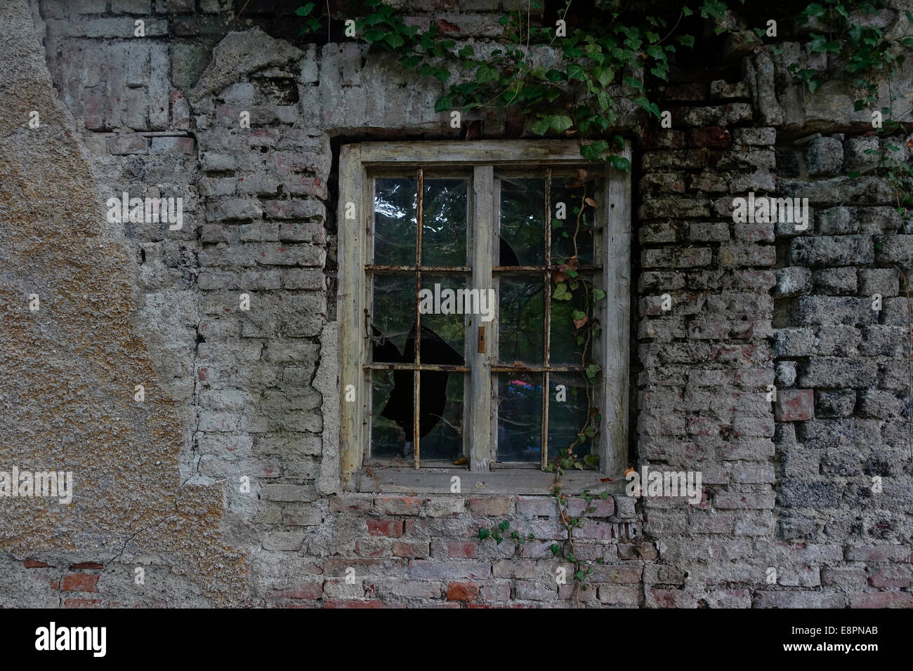 Window in a derelict brick wall of an old house Stock Photo - Alamy