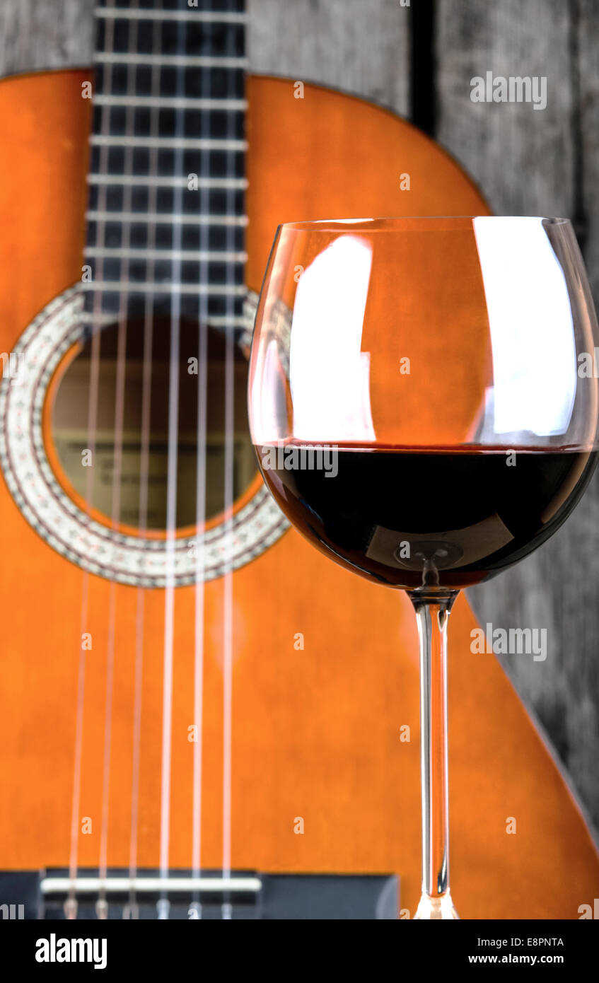Wine and Guitar on a wooden table vintage retro photo Stock Photo