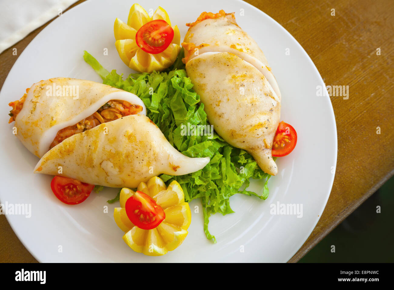 Squid stuffed with seafood in white plate, top view Stock Photo