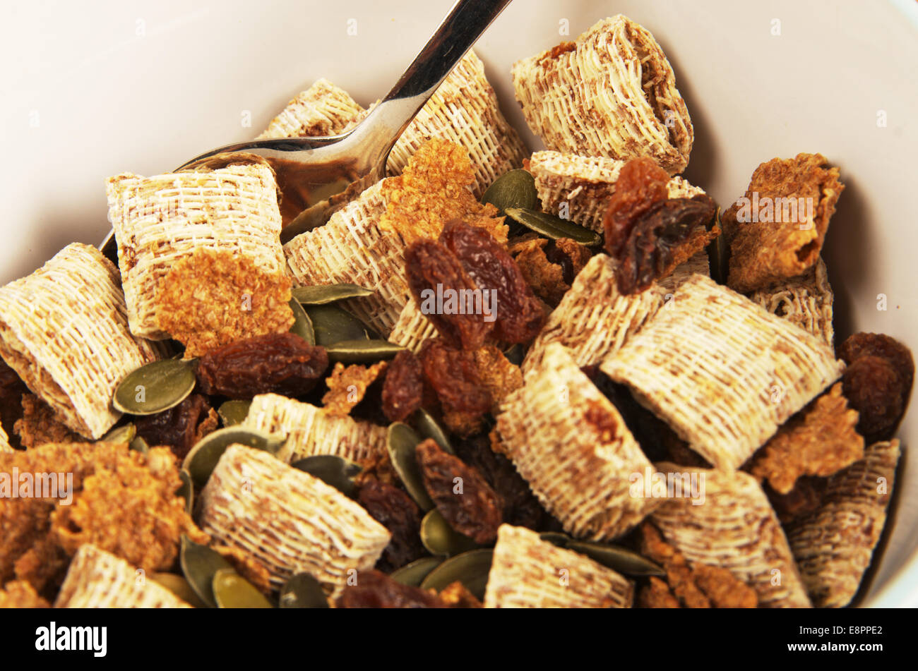 Breakfast cereal in bowl with spoon Stock Photo