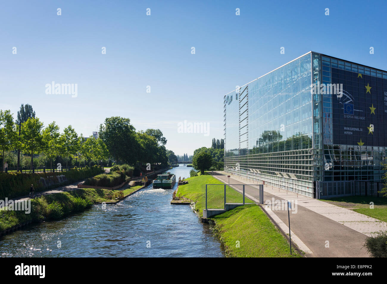 European Parliament building, Strasbourg, France, Europe and a tour boat on the River Ill Stock Photo