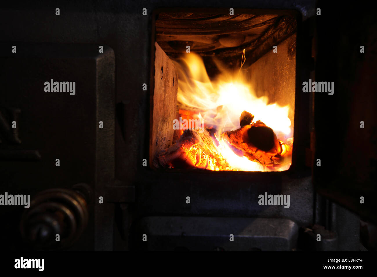 Fire burning in an old wood stove. Stock Photo