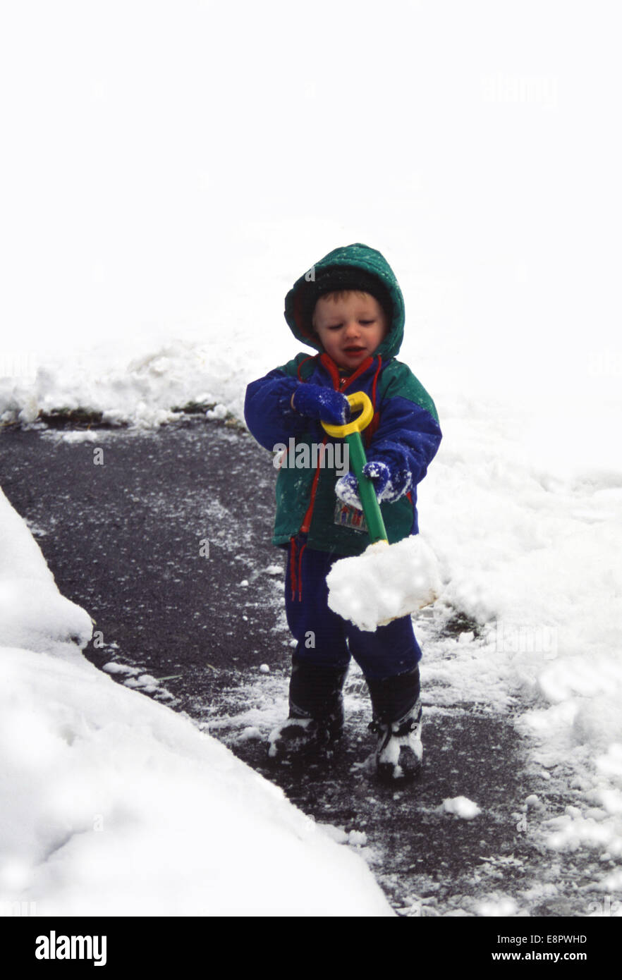 toddler shoveling snow Stock Photo Alamy